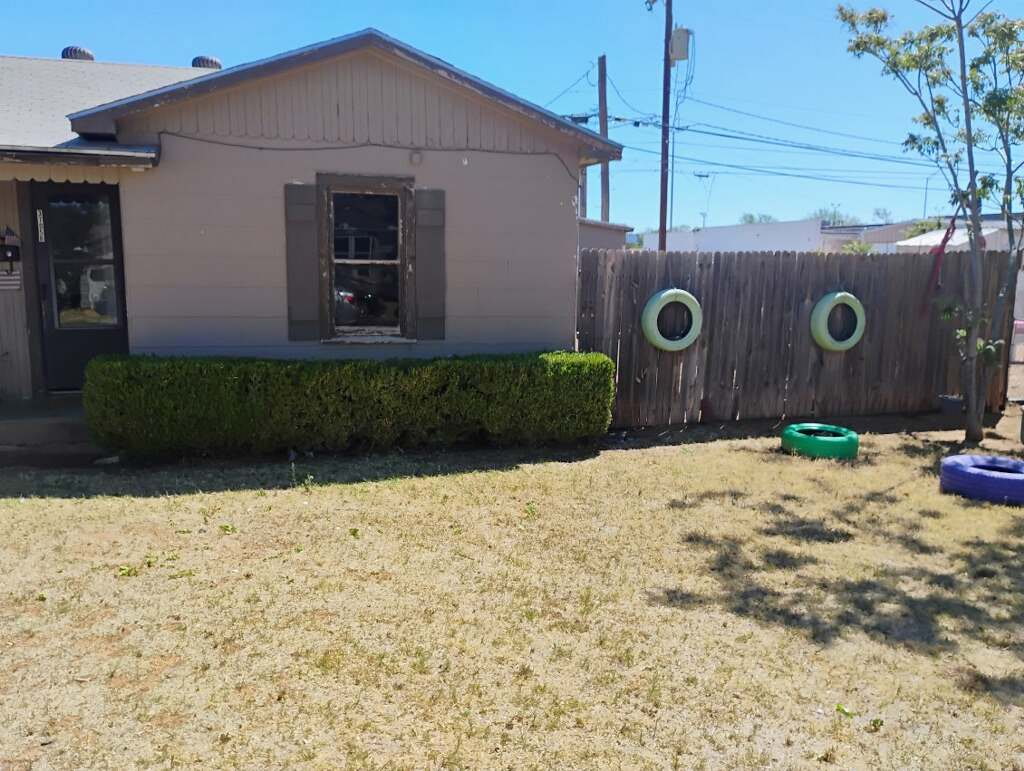 Front yard with neatly trimmed hedges along the house in Lubbock, TX